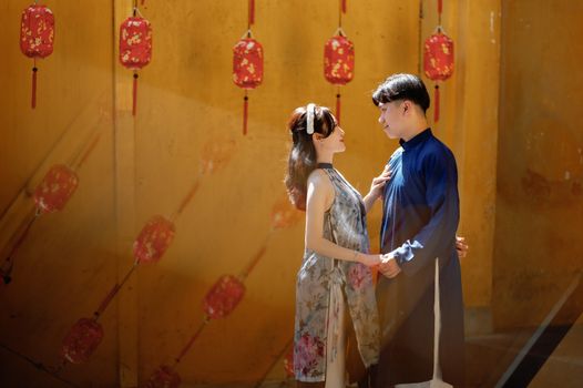 Couple Holding Hands under Red Paper Lanterns