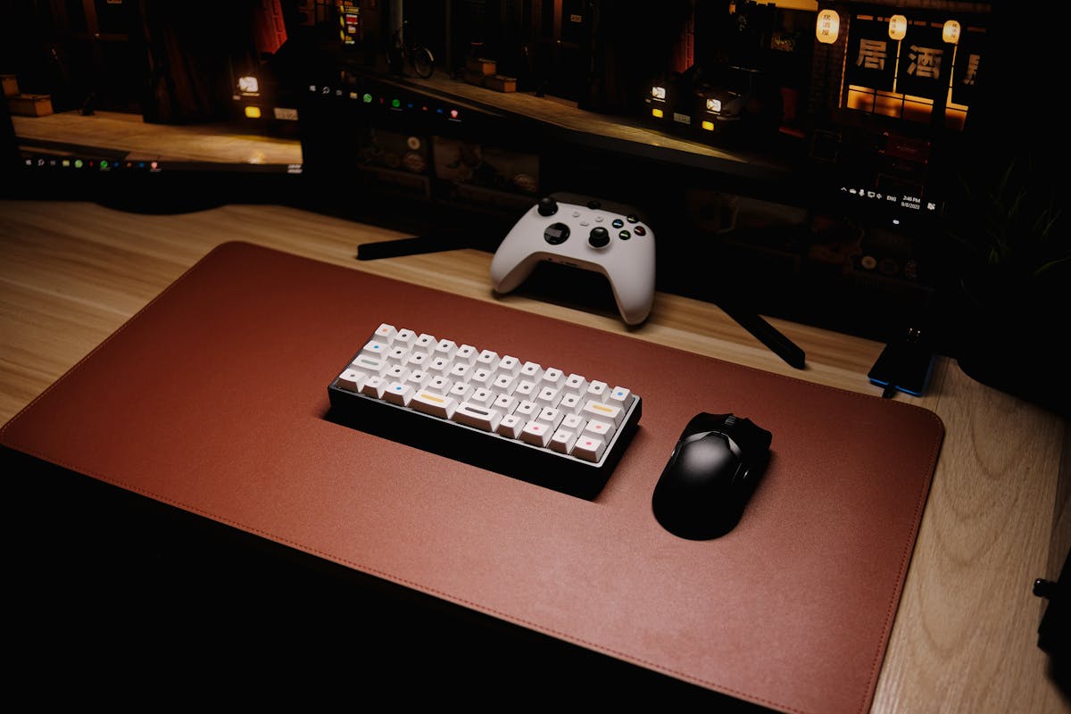 Setup da gioco con tastiera, controller Xbox e schermi vicini