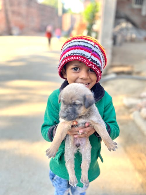 Smiling Boy Holding Puppy