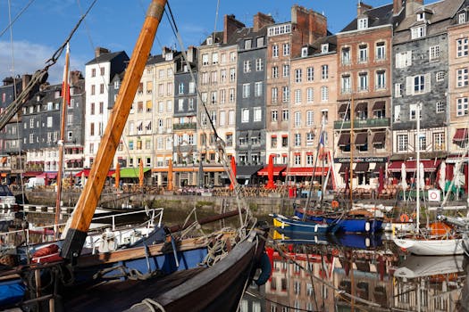 Scenic view of Honfleur harbor with colorful historic buildings reflecting in the calm water.