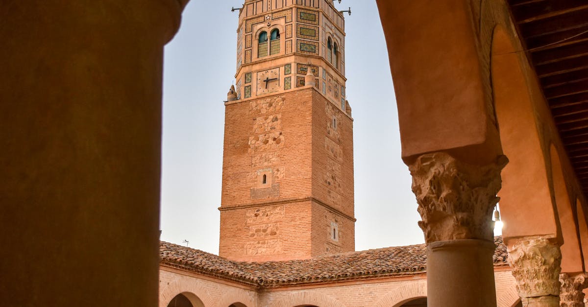 View of the historic minaret and courtyard in Testour, Tunisia, showcasing Islamic architecture.