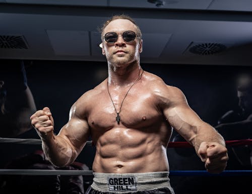 Muscular Boxer Posing in Boxing Ring