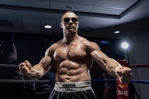 Muscular Man Posing at Boxing Ring