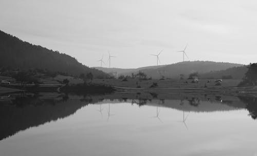 Lake and Hill with Wind Turbines behind