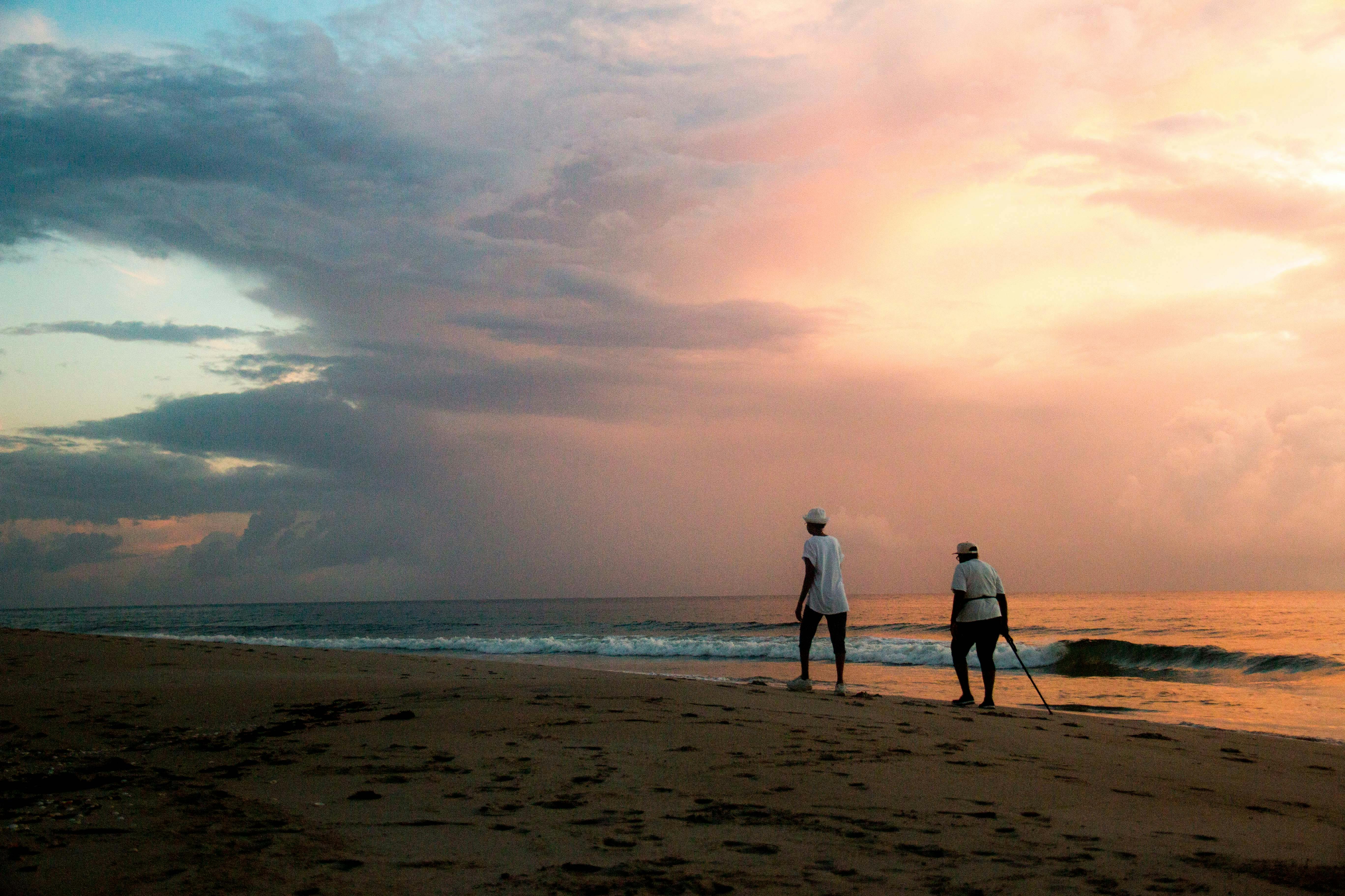 Tourists Walking on the Beach at Sunset · Free Stock Photo, image size:5472x3648