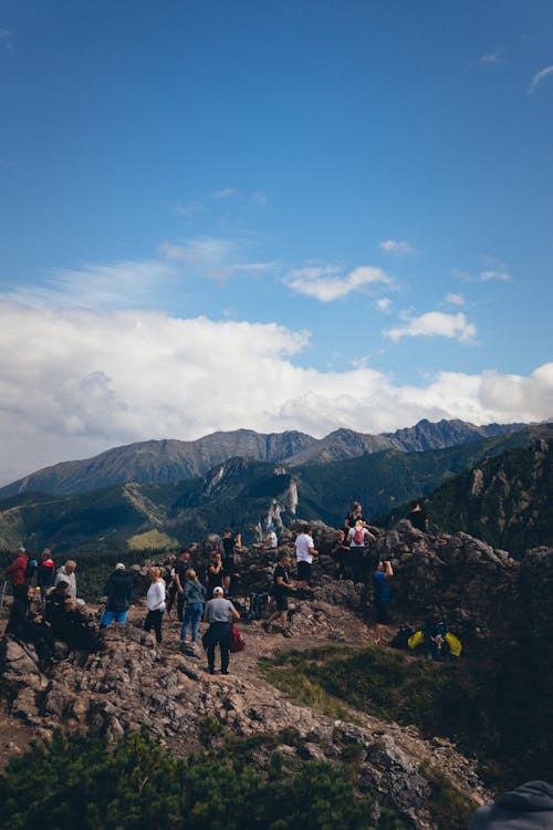 Group of Hikers Resting on Mountain Peak