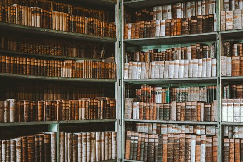Free Discover a vintage library bookshelf filled with timeless old books. Perfect for research and learning ambiance. Stock Photo