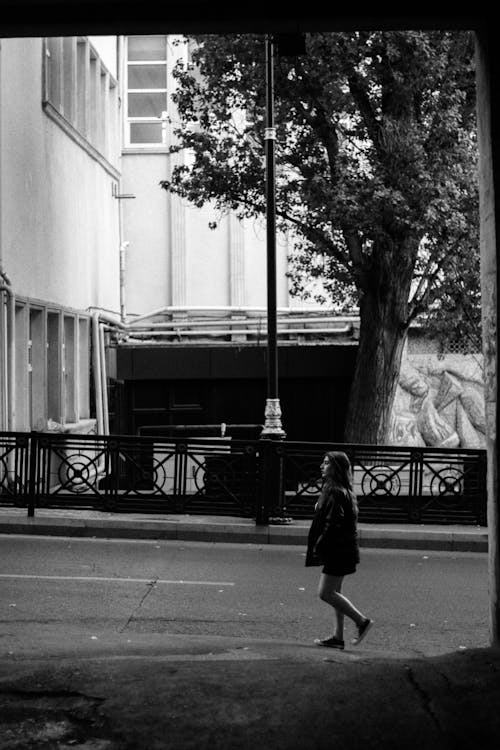 Woman Walking on Street in Trainers