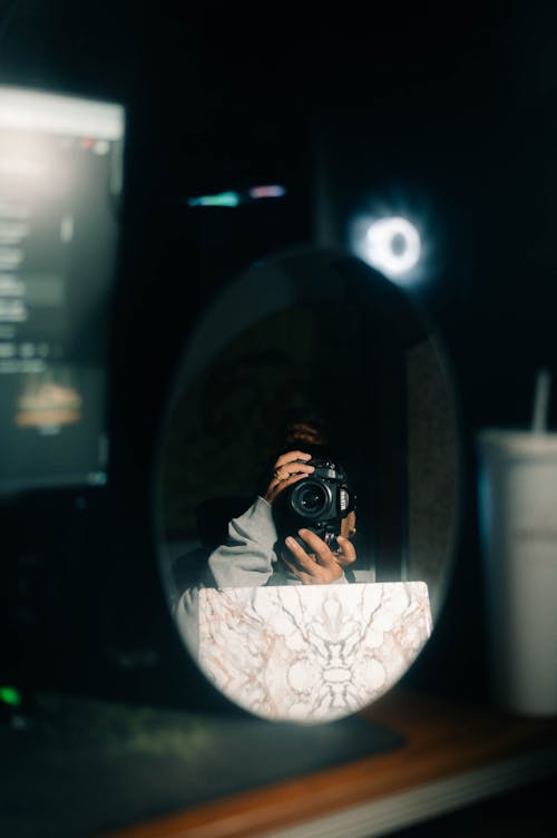 Person with Camera Reflects in Mirror