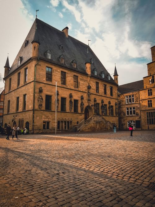 Free Gothic-style Osnabrück Town Hall in Germany captured in warm light, showcasing medieval architecture. Stock Photo