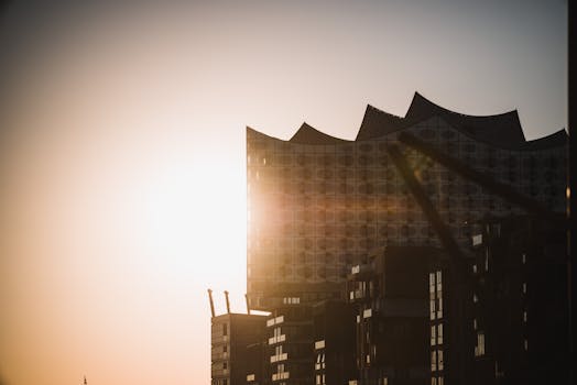 Dramatic sunset highlighting the facade of a modern architectural building.