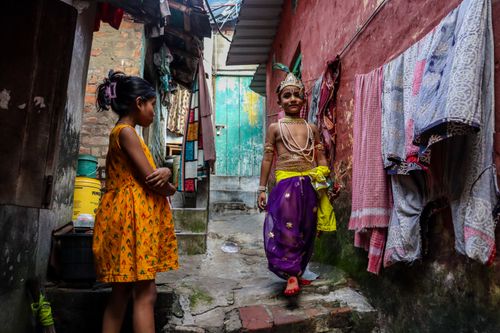 Free Children in traditional attire in a vibrant alley of Kolkata, India, capturing cultural heritage. Stock Photo