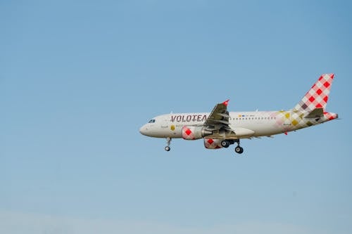 View of a Flying Volotea Airplane against a Blue Sky 