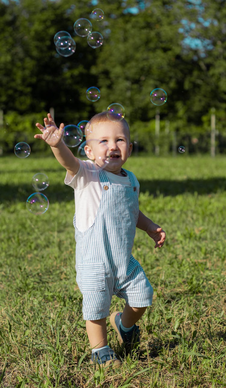 Boy Catching Bubbles