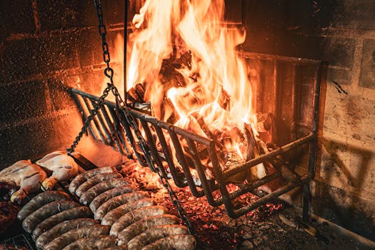 Delicious sausages and chicken grilling over a wood fire in Uruguayana, Brazil.