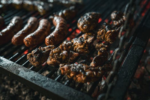 Juicy meats grilling over charcoal, showcasing a traditional asado style barbecue.