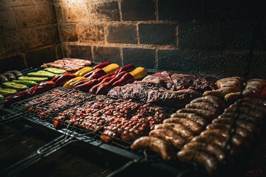 Close-up of assorted meats and vegetables grilling on a Colombian asado in Huila.