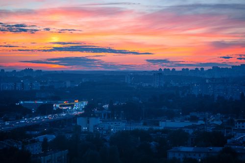 Free Stunning sunrise view over the cityscape of Minsk, featuring dramatic skies and urban skyline. Stock Photo