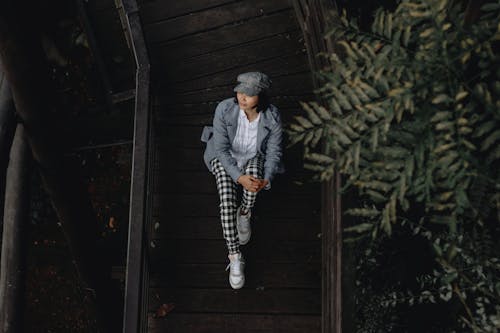 Woman Sitting on Gray Hat and Jacket