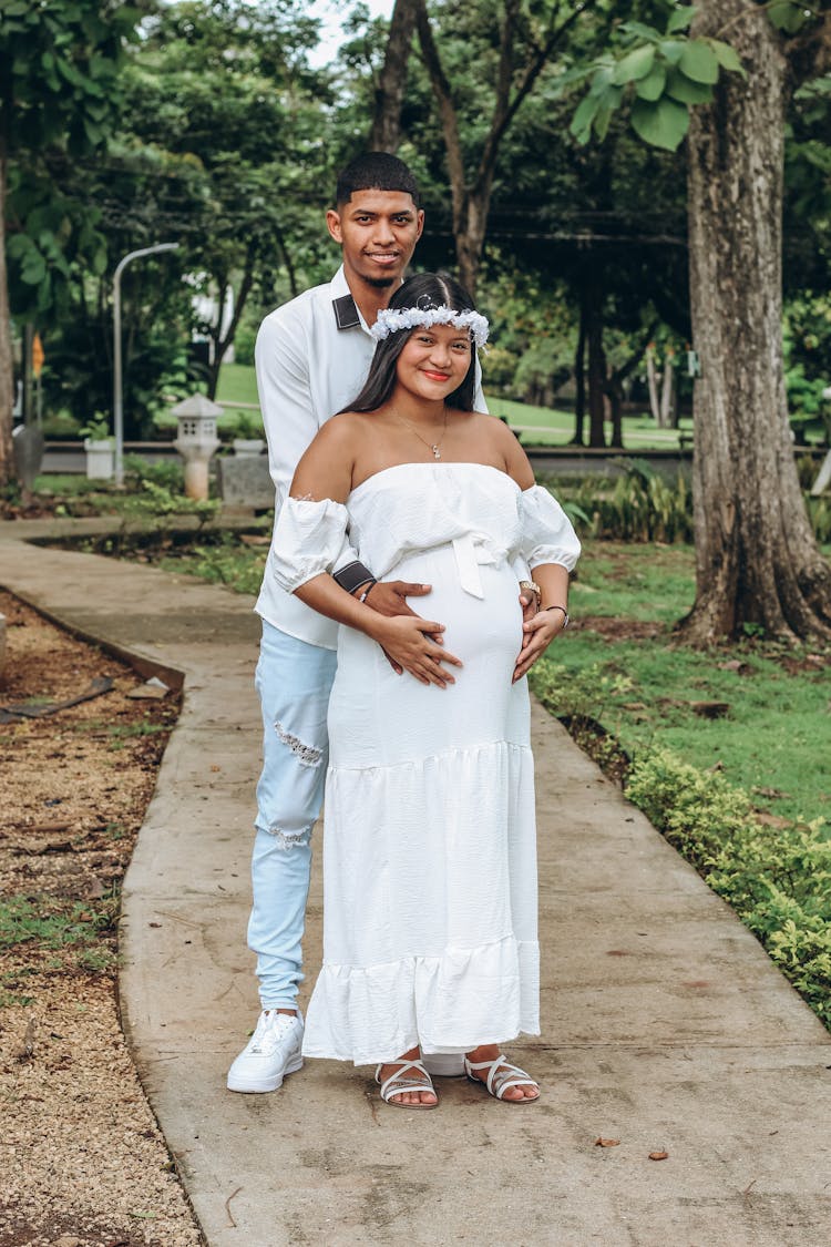 Man And Pregnant Woman In Park