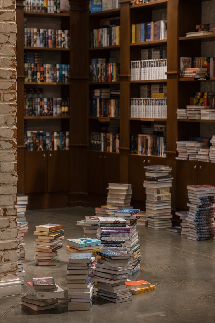 Books On Floor And Shelves In Library