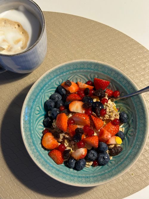 Free Top view of fresh berry oatmeal bowl and coffee on a table. Stock Photo