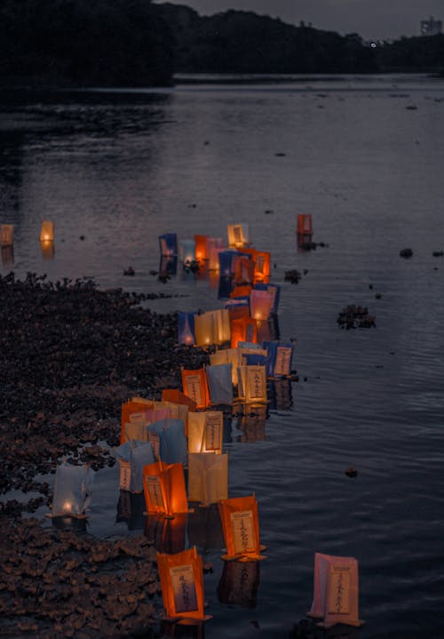 Paper Lanterns Standing and Floating at Seashore