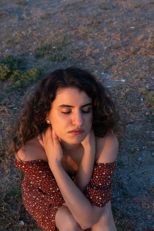 Young Woman Sitting Outside with Eyes Closed