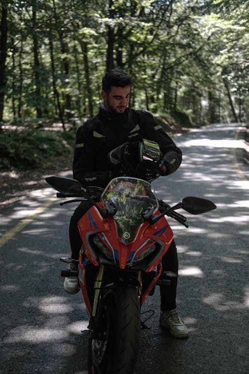 A man on a motorcycle in the woods
