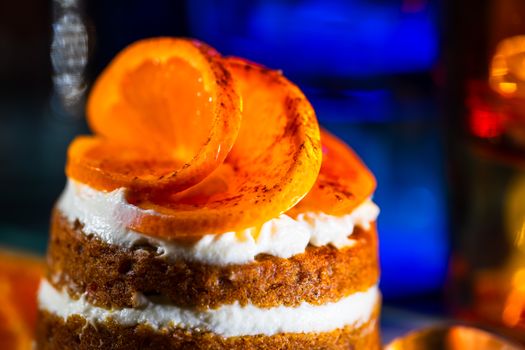 Close-up of a delectable dessert featuring creamy layers topped with caramelized orange slices.