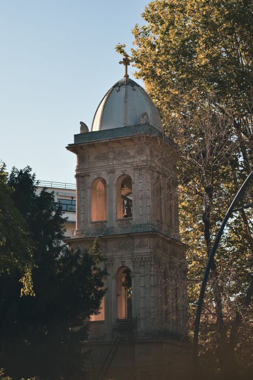 Free A serene view of a historic Greek Orthodox chapel bell tower surrounded by trees in Istanbul. Stock Photo