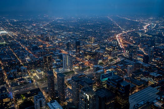 A breathtaking aerial cityscape at night showcasing illuminated roads and skyscrapers, perfect for urban wallpaper.