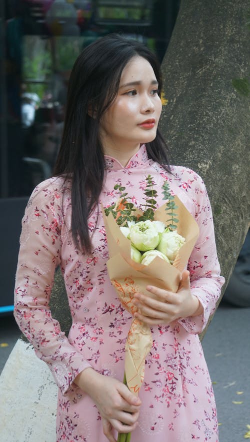 Portrait of Woman in Traditional Clothing and with Flowers Bouquet