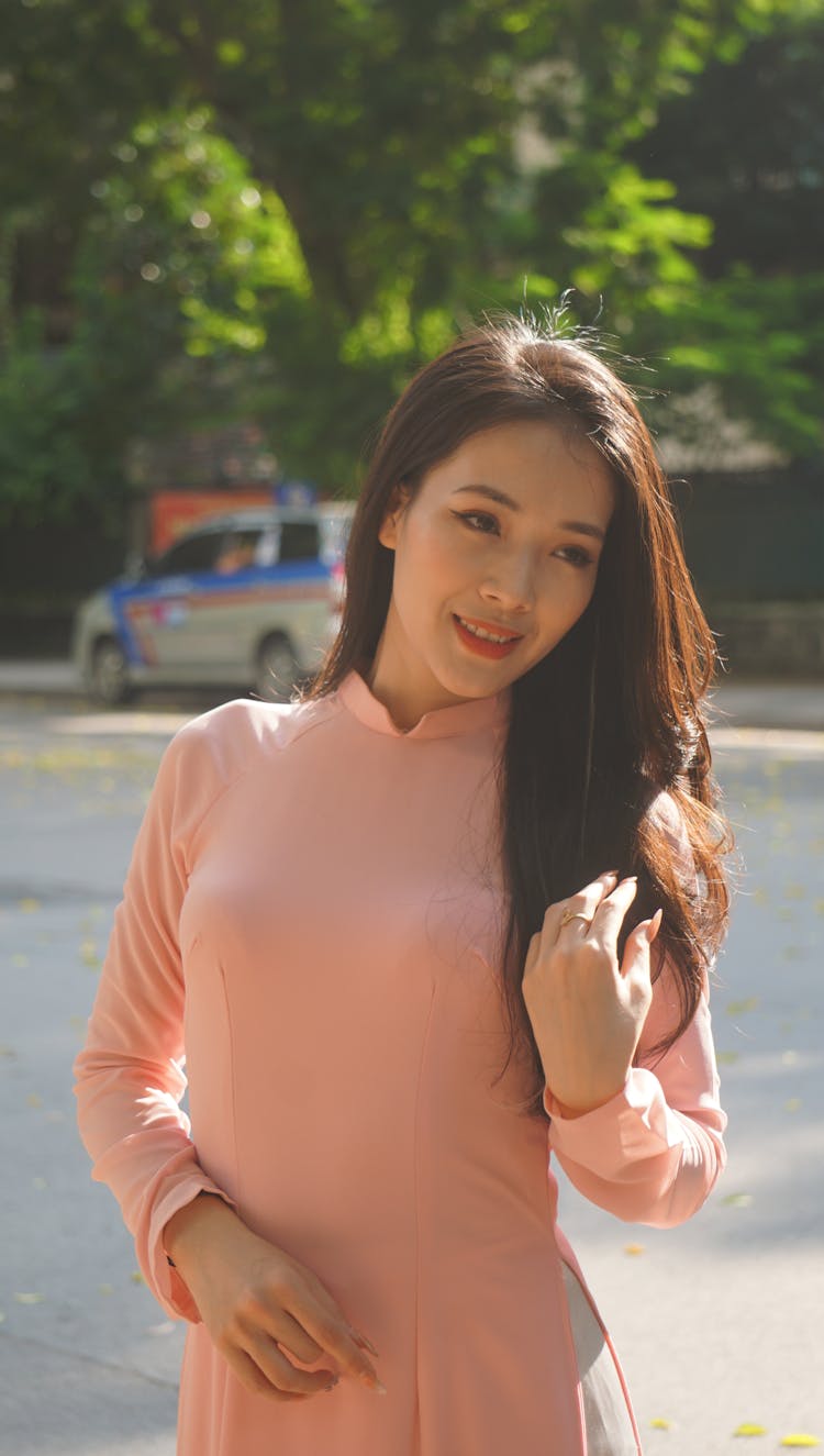 Woman In A Pink Blouse Smiling For A Photo