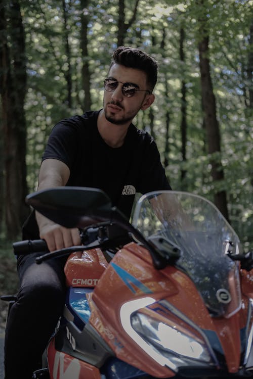 A man in sunglasses riding a motorcycle