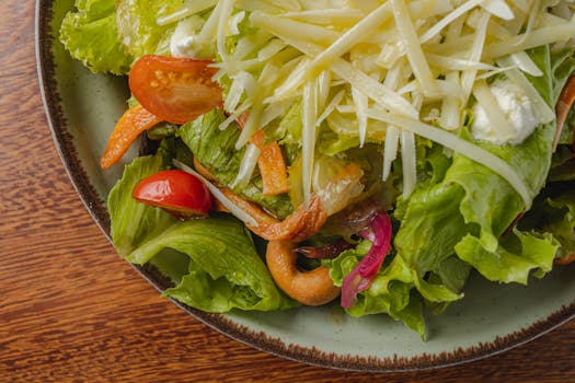 Healthy vegetarian salad with cheese, lettuce, tomatoes, and peppers, offering a colorful and delicious meal.