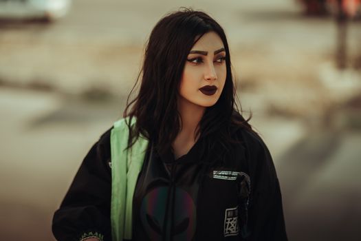 Stylish portrait of a woman with dark makeup and fashion attire in Urmia, Iran.