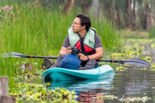 Free A man kayaking in CDMX, México, capturing nature photography. Adventure in serene water landscape. Stock Photo