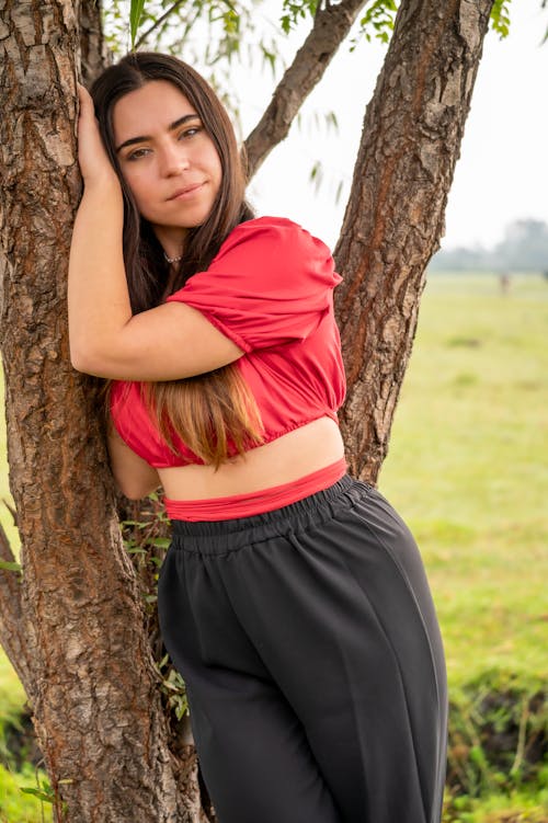 A Woman Standing by a Tree