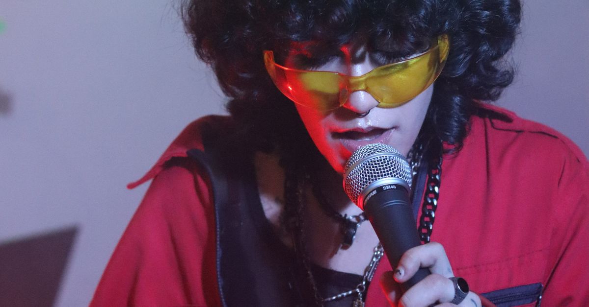 Singer in Jacket with Microphone · Free Stock Photo