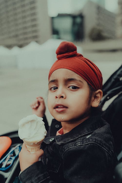 Kid in Headscarf Eats Ice Cream in Cone