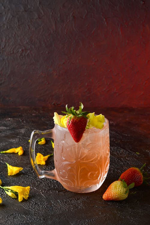 Free Cocktail Glass Decorated with Yellow Flowers and Strawberries Stock Photo