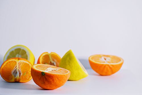 Free Colorful citrus slices including oranges and lemons displayed on a white background. Stock Photo