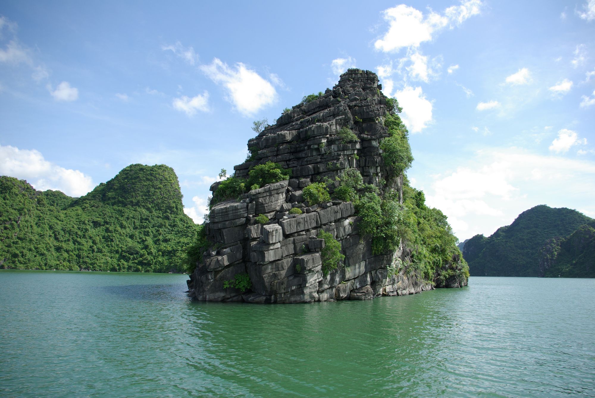 Limestone karsts rising from the emerald water of Ha Long Bay, Vietnam