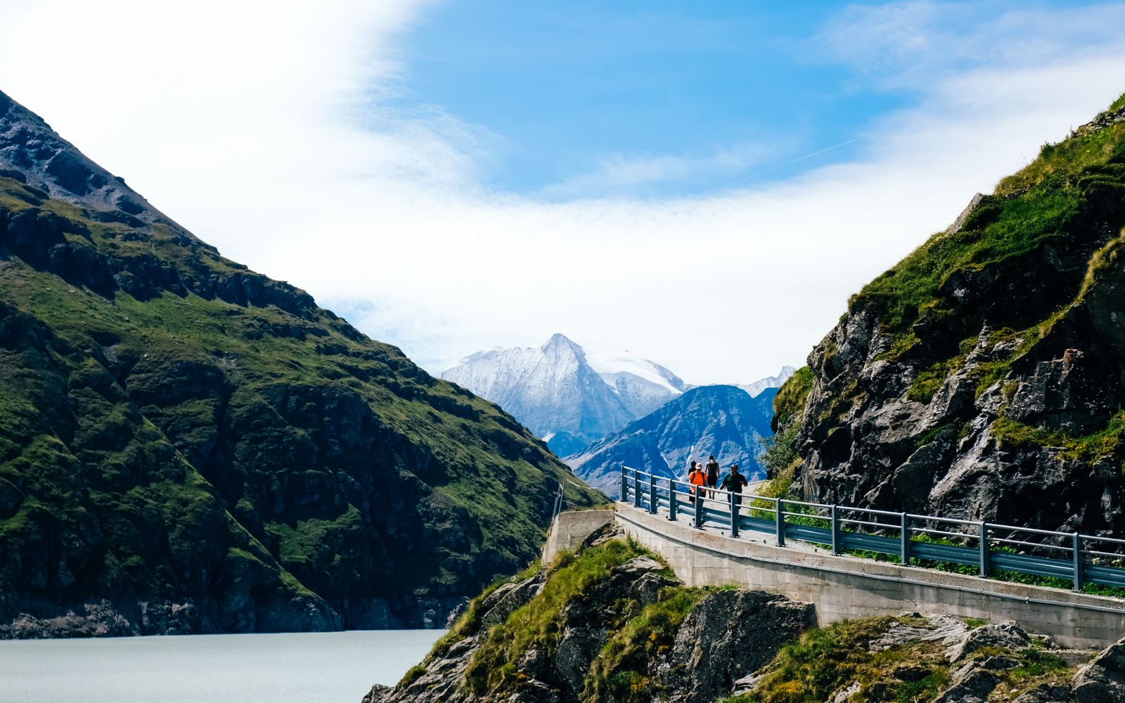 Runners beside a mountain lake