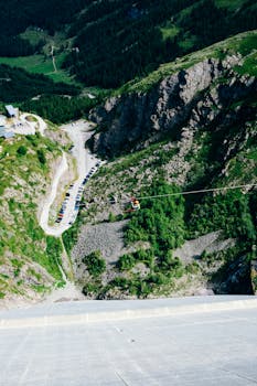 Experience thrilling zipline ride over beautiful mountainous terrain in summer.