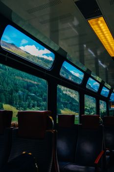 Experience a tranquil train ride with panoramic views of mountains and forests.