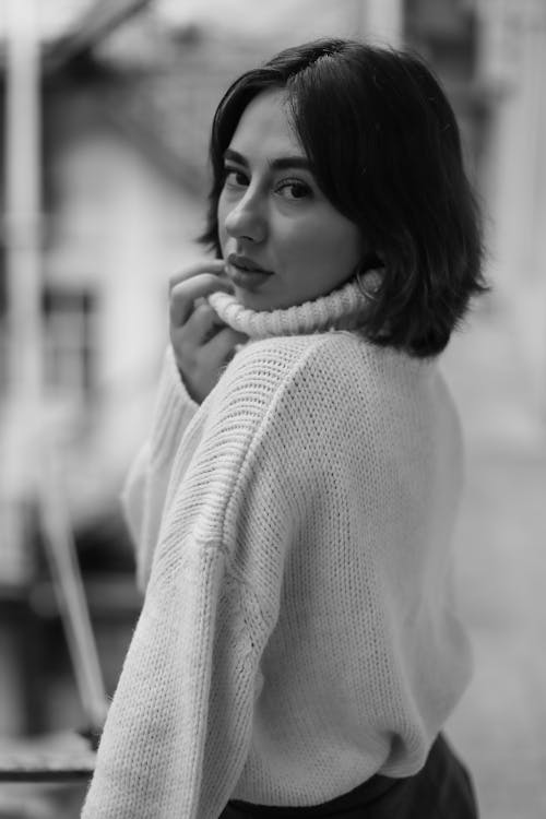 Free Black and White Picture of a Young Woman in a Sweater  Stock Photo