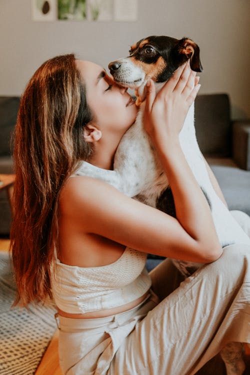 Woman Kissing and Hugging Dog