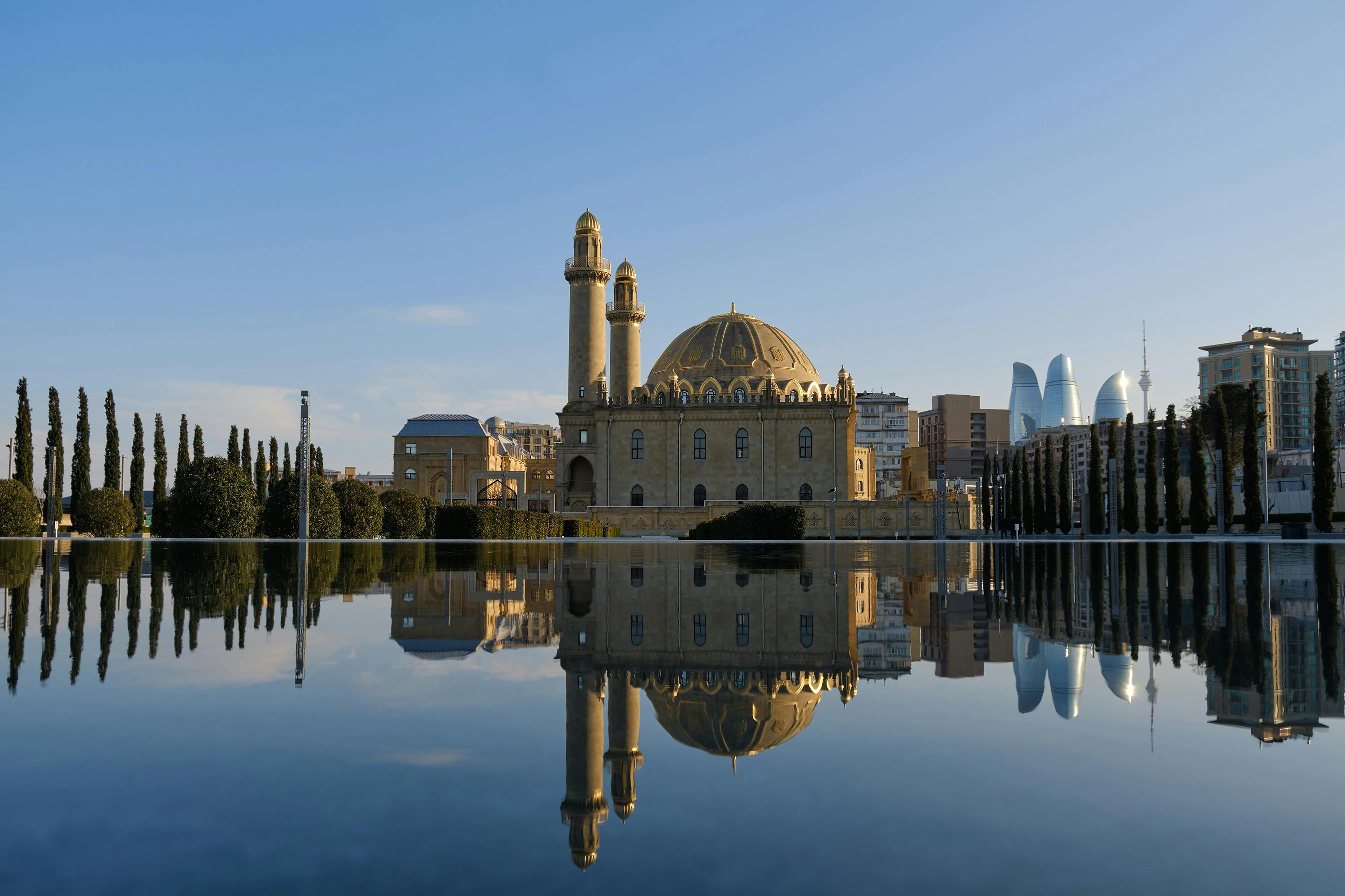 Breathtaking reflection of Taza Pir Mosque in Baku, Azerbaijan, showcasing Islamic architecture.